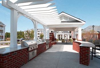 Outdoor entertaining area with gas grills, tvs and a fireplace